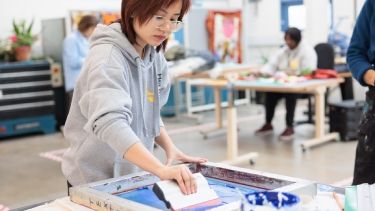 Hertfordshire International College Student gaining hands on experience printing