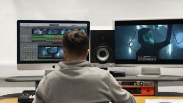 Single male University of Hertfordshire student using media editing facilities.