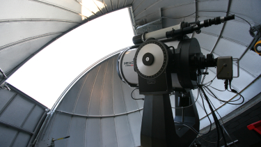 A telescope looking out at an observatory