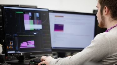 Single male Hertfordshire International College student using university facilities to create video animation.
