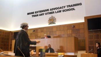The interior of a law court, alongside the text 'More extensive advocacy training than any other law school'